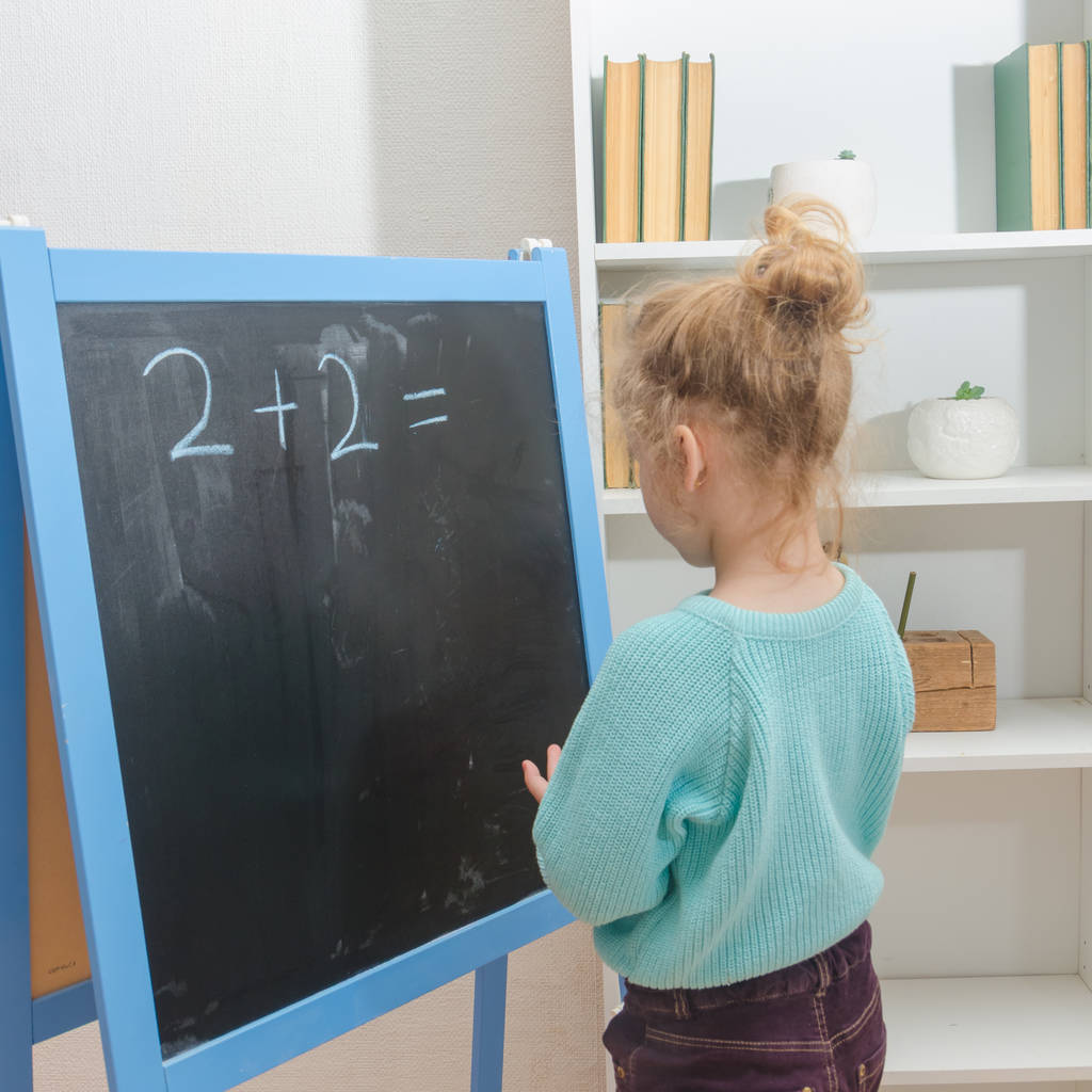 girl, a schoolboy on a chalkboard solves mathematical examples - Photo, Image