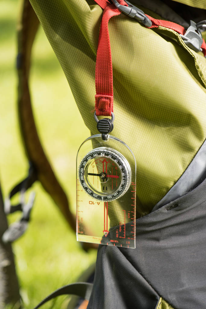 close-up view of compass hanging on backpack  - Photo, Image