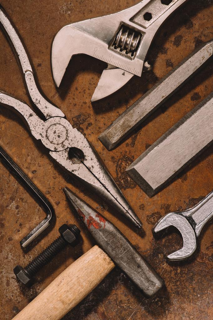 top view of old shabby mechanical tools on brown surface  - Photo, Image
