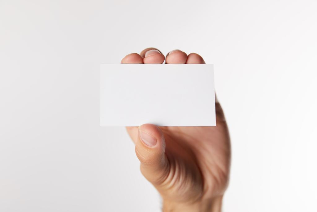 περικομμένη εικόνα του επιχειρηματία δείχνει άδειο επισκεφθείτε κάρτα που απομονώνονται σε λευκό φόντο  - Φωτογραφία, εικόνα