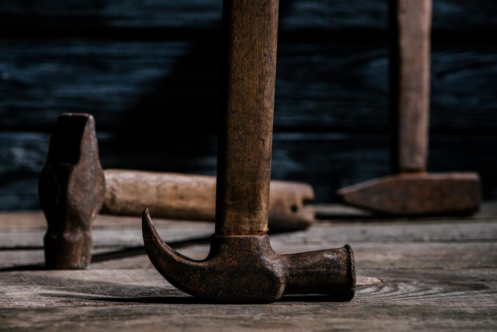 close up view of retro rusty hammers on wooden planks surface - Photo, Image