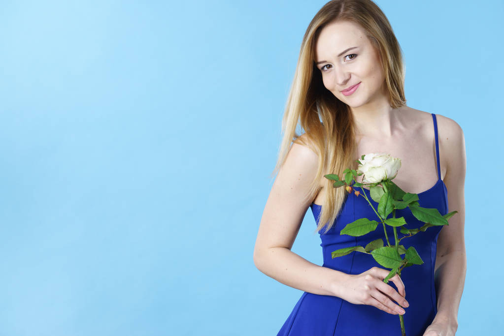 Attractive blonde young woman holding white rose flower. Valentines and womens day, gift concept. - Photo, Image