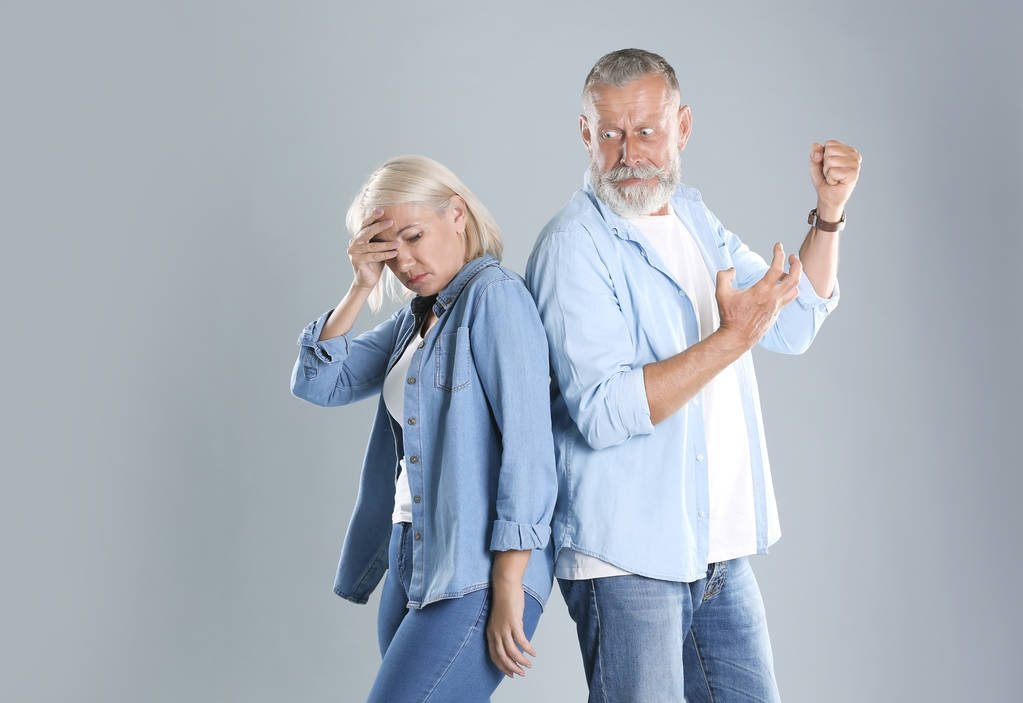 Couple d'âge mûr se disputant sur fond gris. Problèmes relationnels
 - Photo, image