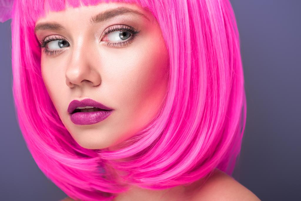 beautiful young woman with pink bob cut isolated on violet - Photo, Image