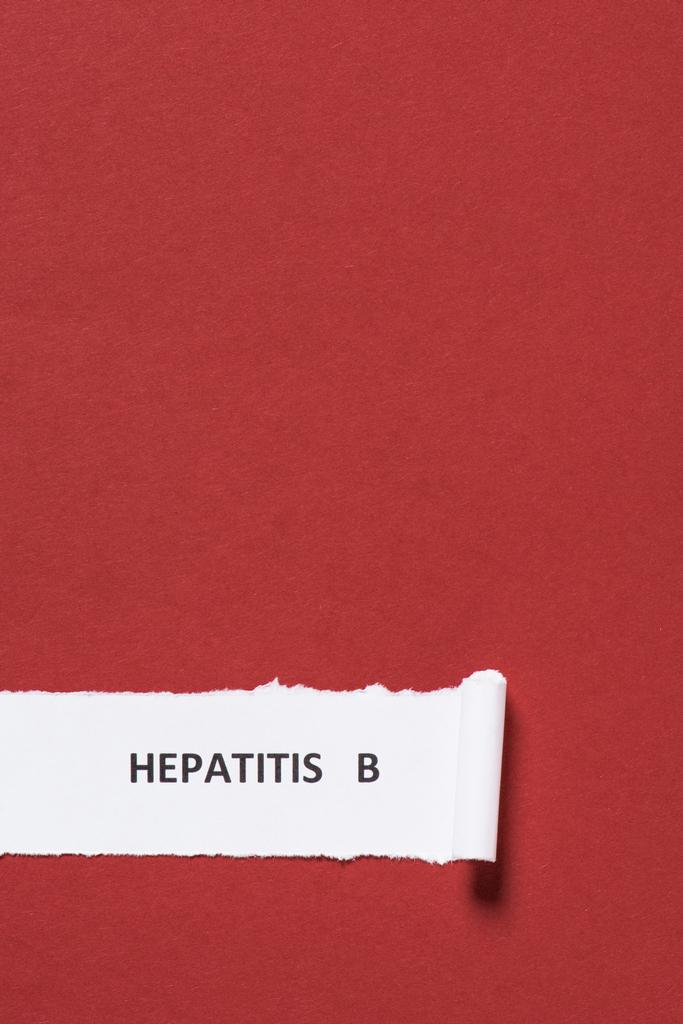 elevated view of lettering hepatitis b on paper on red background, world hepatitis day concept - Photo, Image