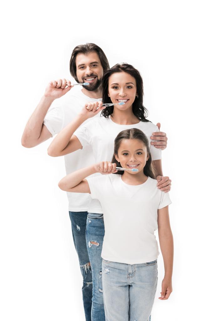 portrait of smiling family in white shirts with toothbrushes isolated on white - Photo, Image