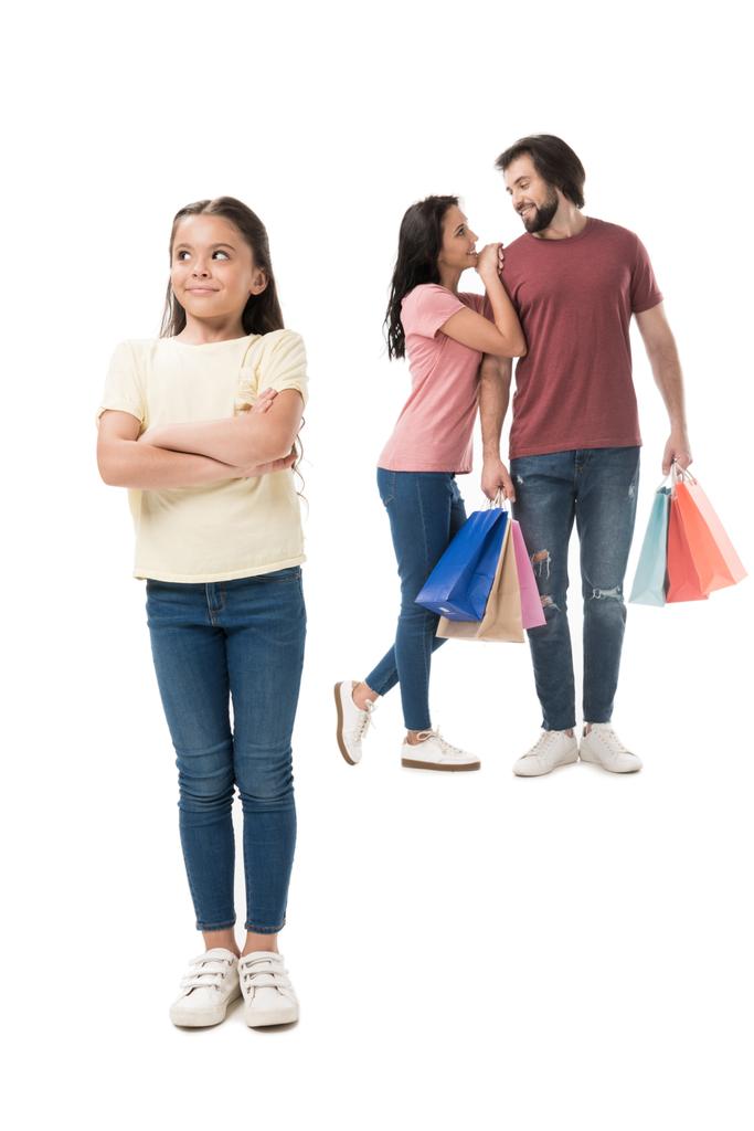 szelektív összpontosít a kis gyerek keres el és a szülők a bevásárló szatyrok mögött a elszigetelt fehér - Fotó, kép
