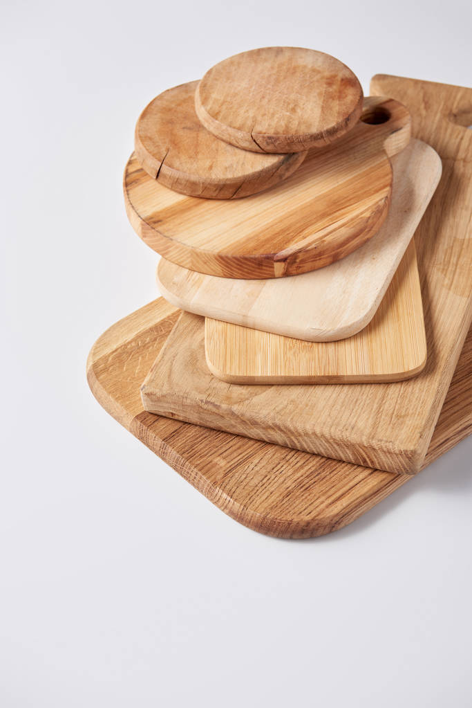 selective focus of stack of different wooden cutting boards on white table - Photo, Image
