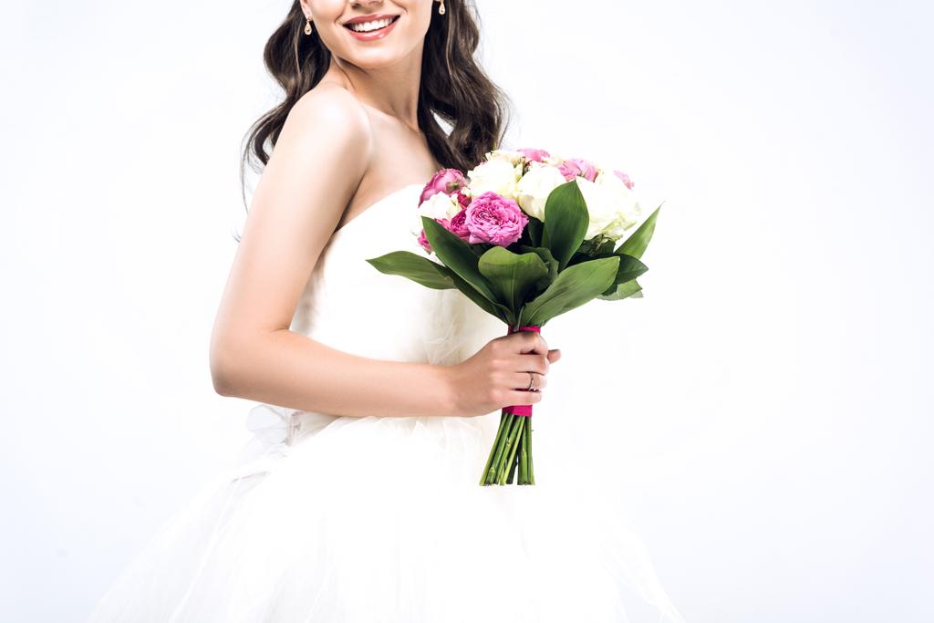 plan recadré de jeune mariée souriante en robe de mariée avec bouquet isolé sur blanc
 - Photo, image