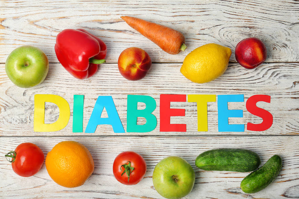 Flat lay composition with word "Diabetes", fruits and vegetables on wooden background - Photo, Image