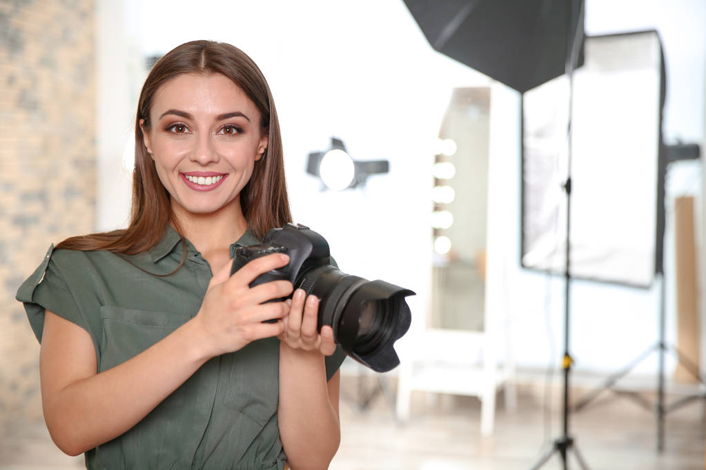 Professional photographer with camera in photo studio - Photo, Image