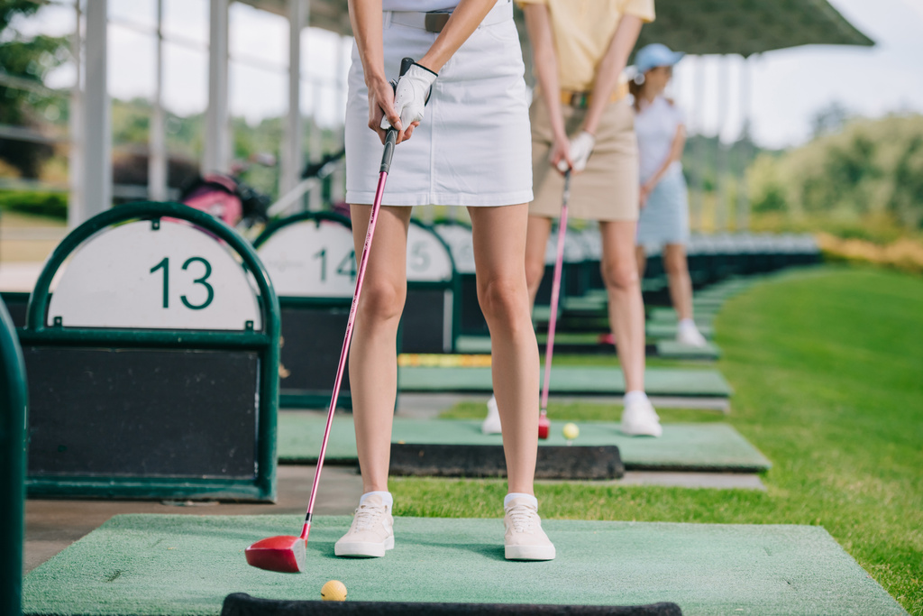 partial view of women with golf clubs playing golf at golf course - Photo, Image