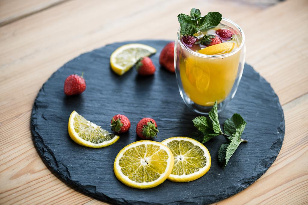 fruity summer cocktail with strawberries and mint in glass on slate board - Photo, Image