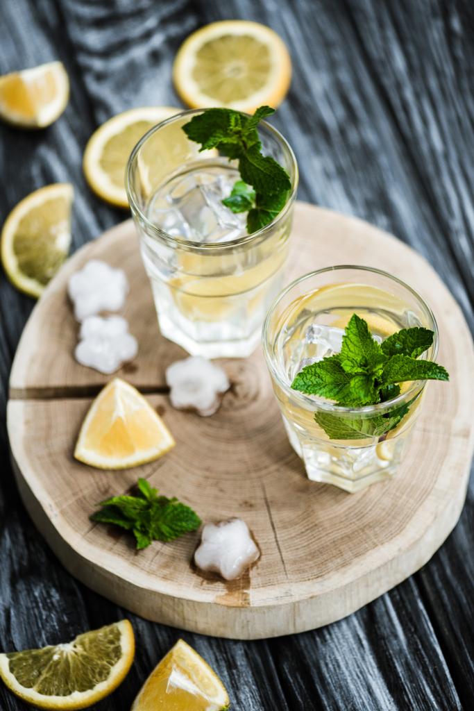 high angle view of cold fresh mojito cocktail in glasses on wooden surface - Photo, Image