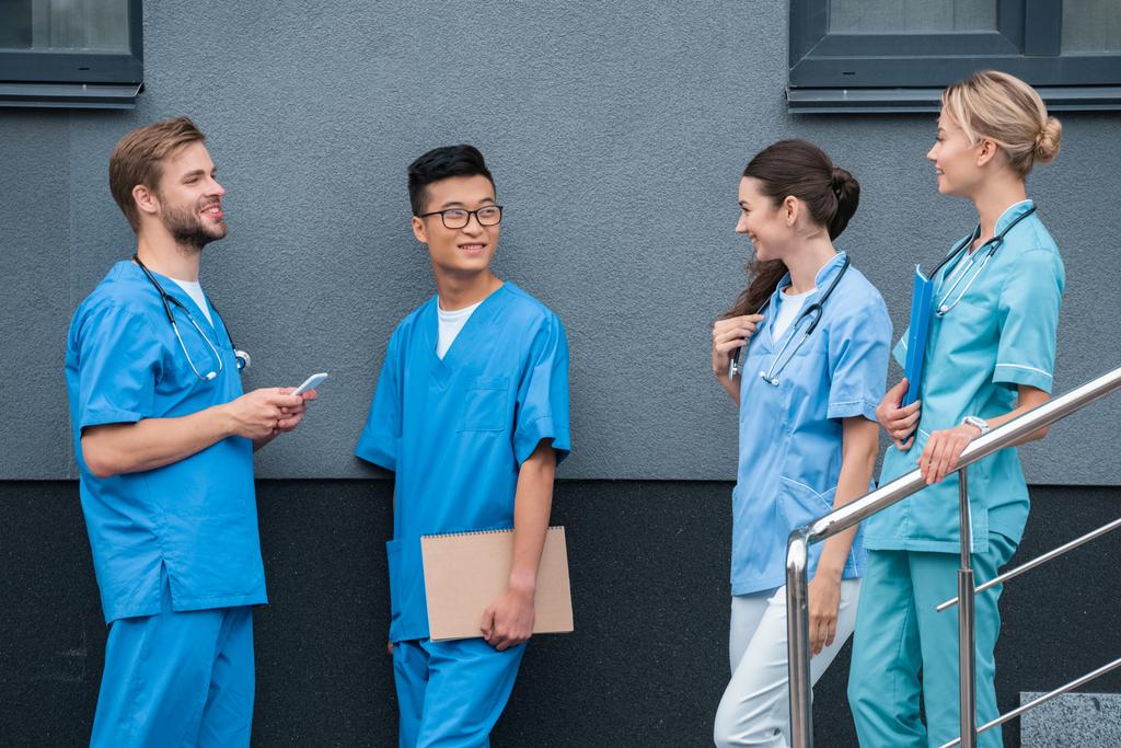 мультикультурні студенти-чоловіки та жінки-медики дивляться один на одного в медичному університеті
 - Фото, зображення