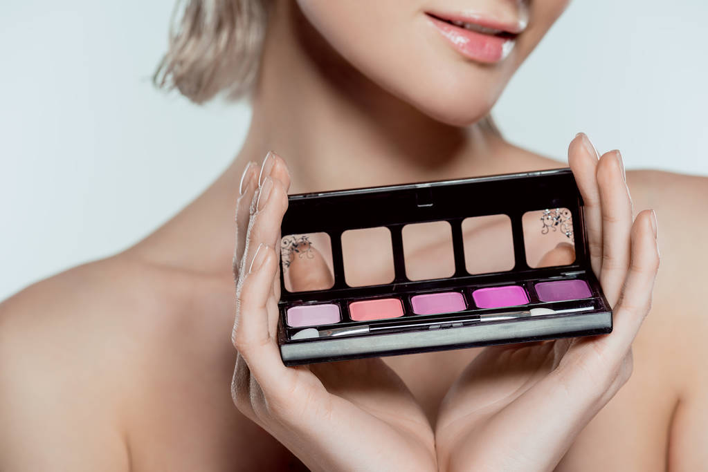 cropped view of girl holding palette with eyeshadows, isolated on grey - Photo, Image