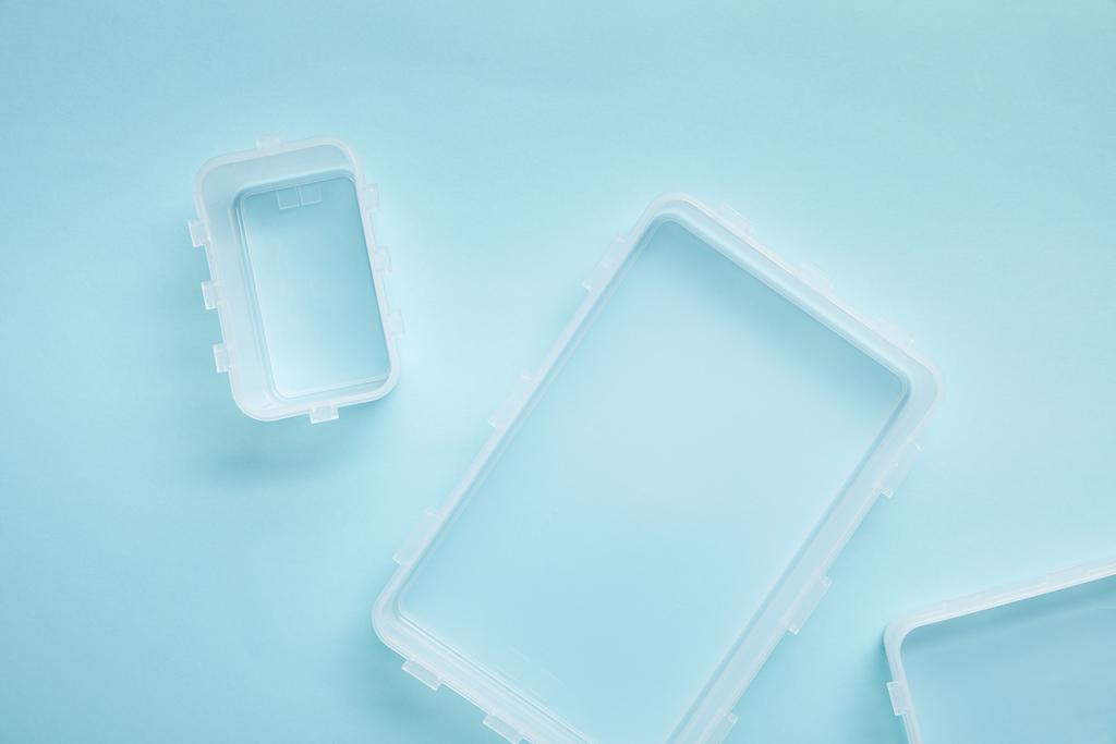 top view of empty lunch boxes isolated on blue - Photo, Image