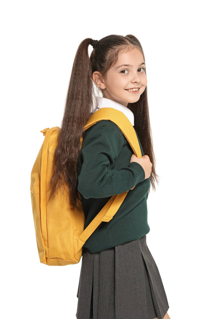Klein meisje in stijlvolle school uniform op witte achtergrond - Foto, afbeelding