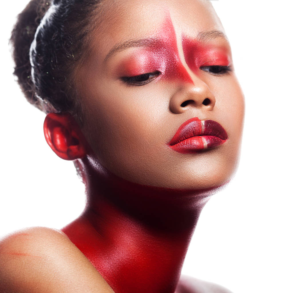 Νεαρό κορίτσι μελαχροινός με αφηρημένα ασύμμετρο κόκκινο make-up. Close-up πορτρέτο ομορφιά - Φωτογραφία, εικόνα