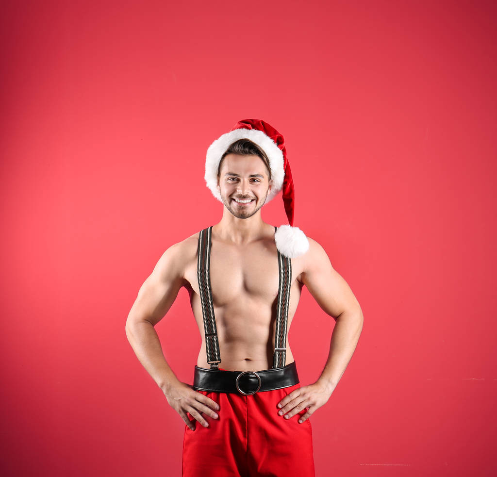 Shirtless young Santa Claus with sexy body on color background - Photo, Image