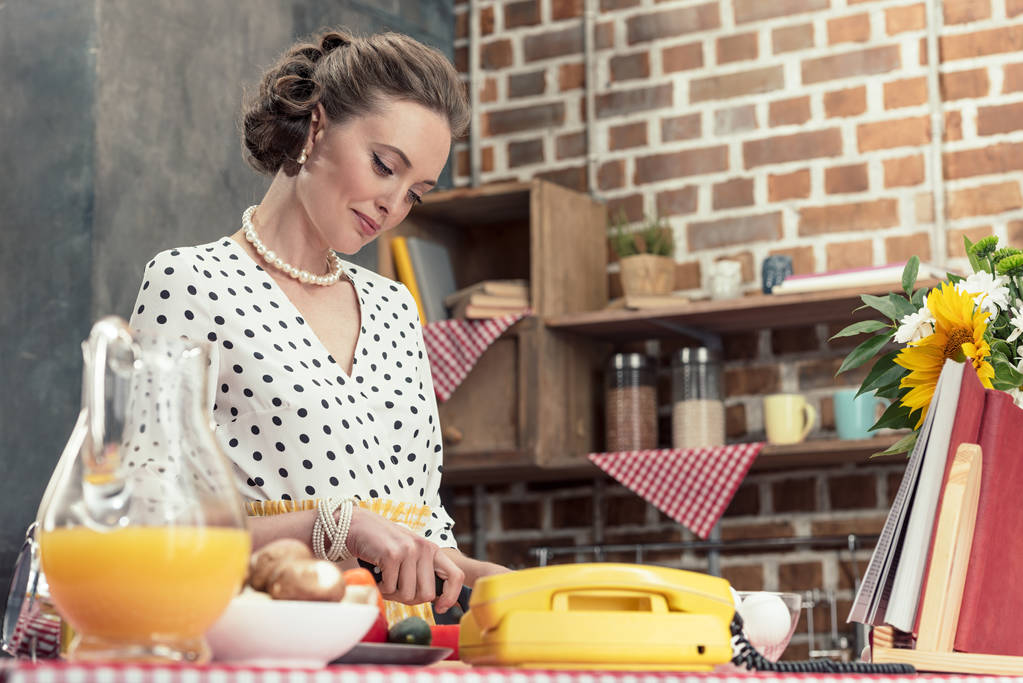 beautiful adult housewife in vintage clothes cooking at kitchen - Photo, Image