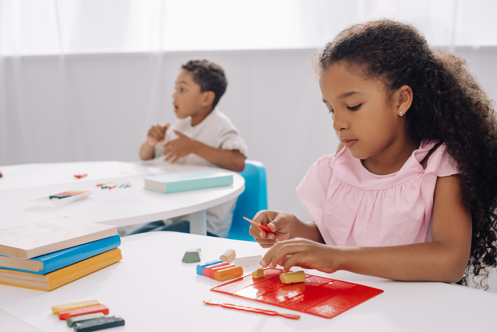 selective focus of african american kid with plasticine sculpturing figure in classroom - Photo, Image
