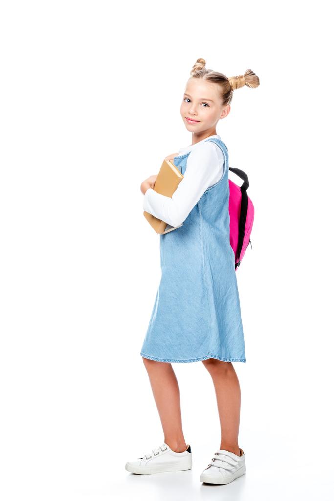 adorable schoolchild with pink backpack holding books and looking at camera isolated on white - Photo, Image
