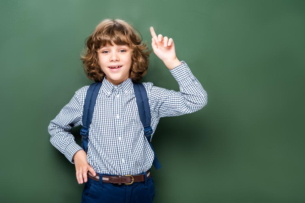 schoolboy showing idea gesture near blackboard - Photo, Image