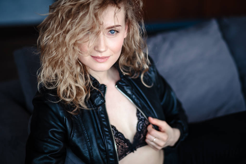 Close-up portrait of sexy blonde woman in a black leather jacket and lacy bra, fashion beauty photo - Photo, Image