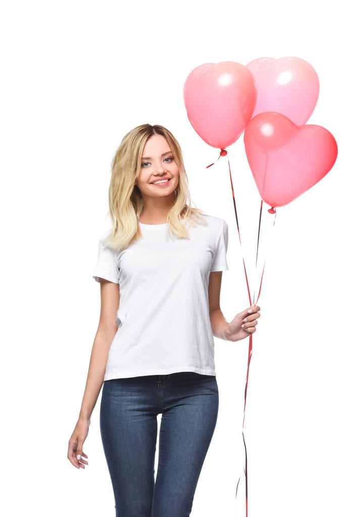 happy attractive girl in white shirt holding bundle of heart shaped balloons isolated on white - Photo, Image