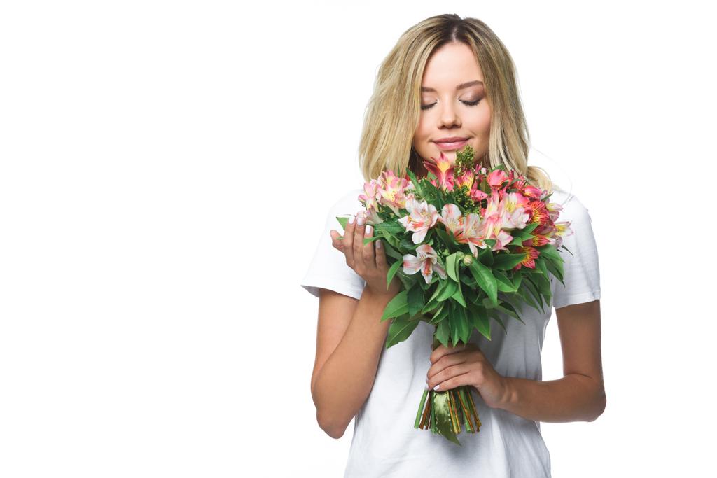 attraente ragazza in camicia bianca fiuto bouquet di fiori con gli occhi chiusi isolati su bianco
 - Foto, immagini