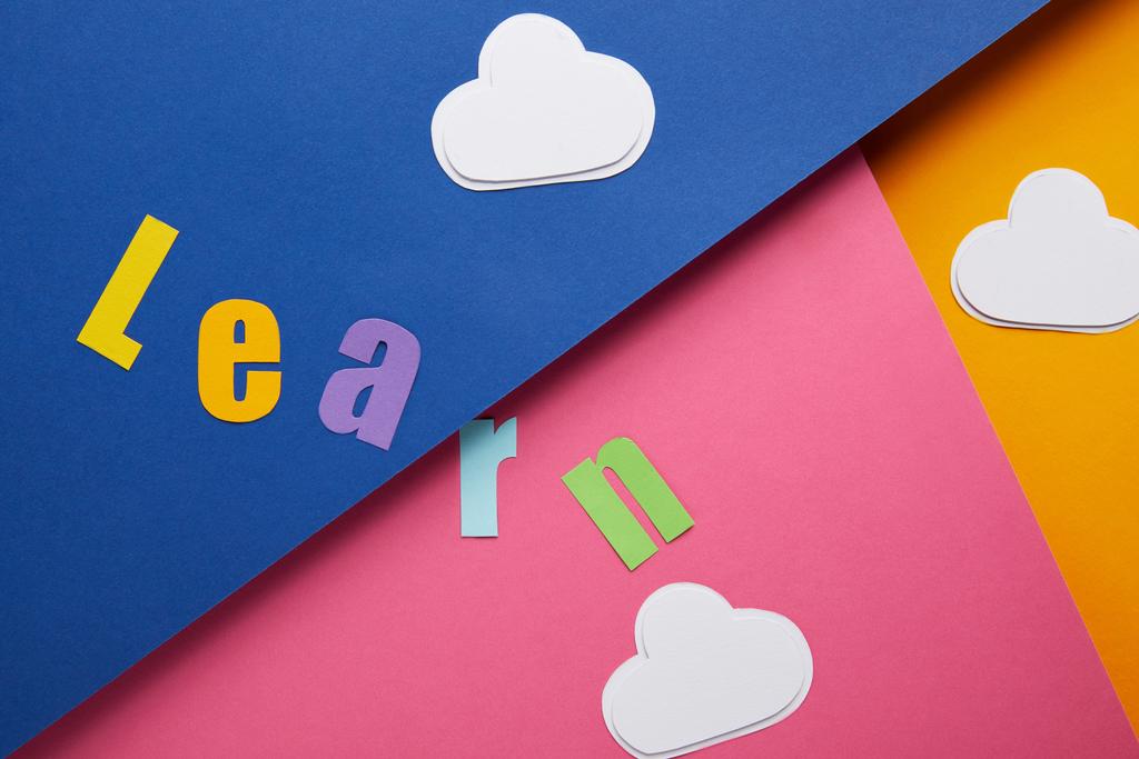 "learn "lettering with clouds on colorful paper background
 - Фото, изображение