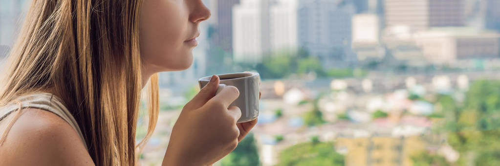 Young woman drinking coffee on balcony.  - Photo, Image
