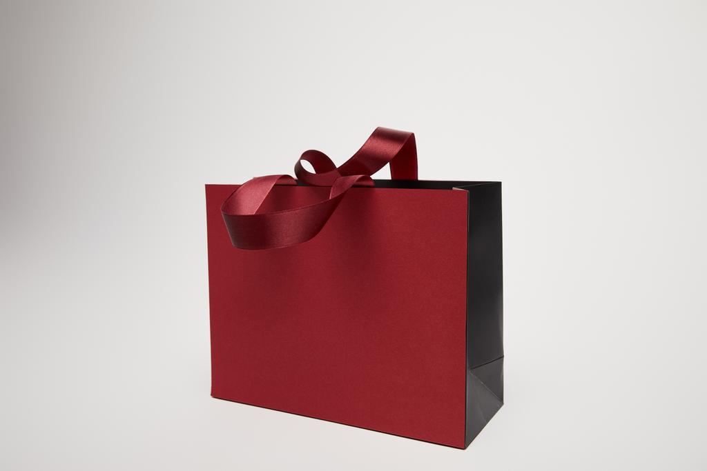 one new burgundy shopping bag isolated on white - Photo, Image