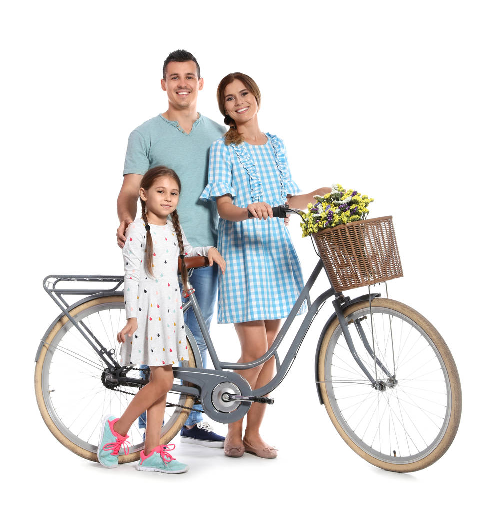 Portrait of parents and their daughter with bicycle on white background - Photo, Image