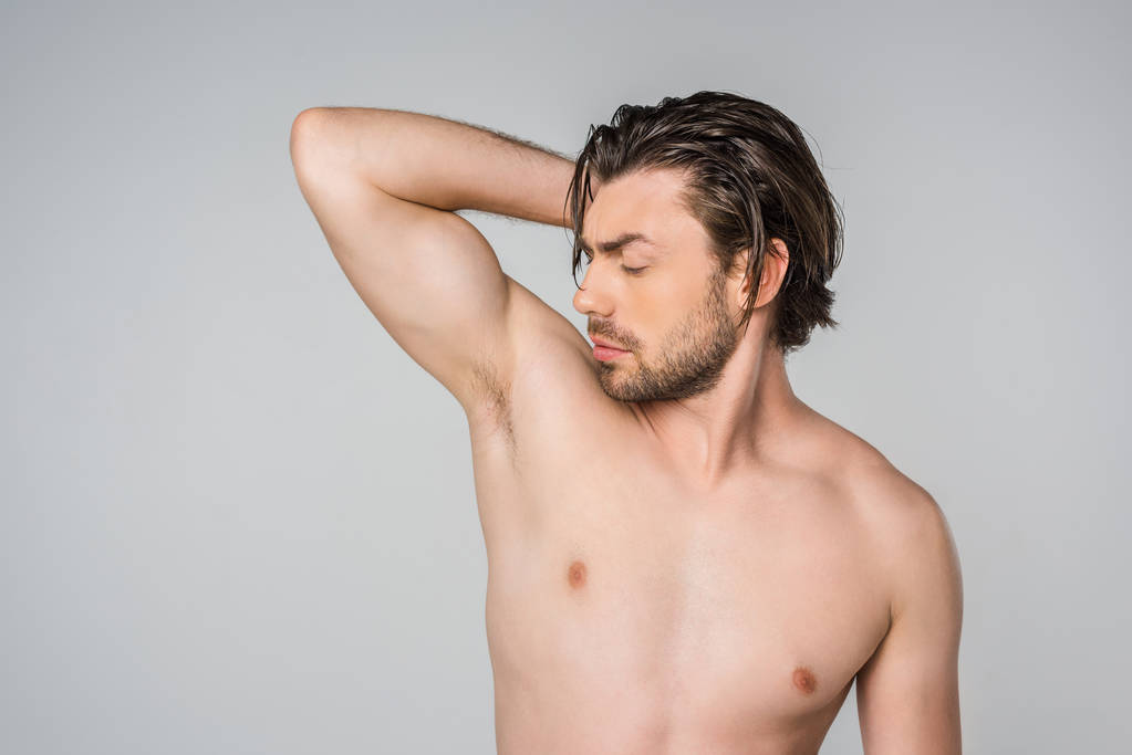 portrait of handsome shirtless man with arm up isolated on grey - Photo, Image