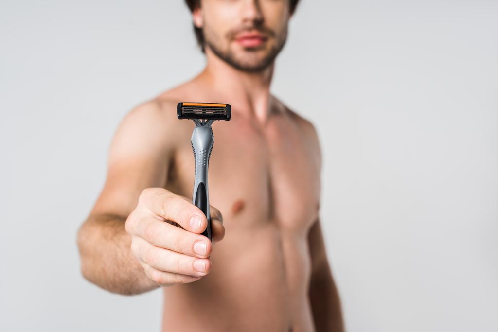 selective focus of shirtless man with razor in hand isolated on grey - Photo, Image