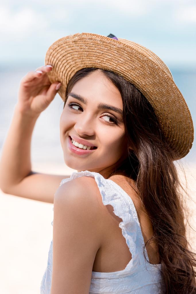 beautiful cheerful woman posing in straw hat at summertime - Photo, Image