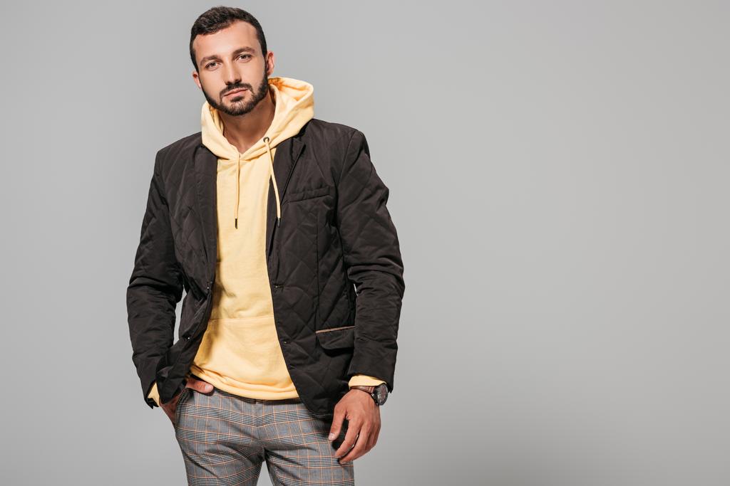 confident male model in autumn outfit posing isolated on grey background  - Photo, Image