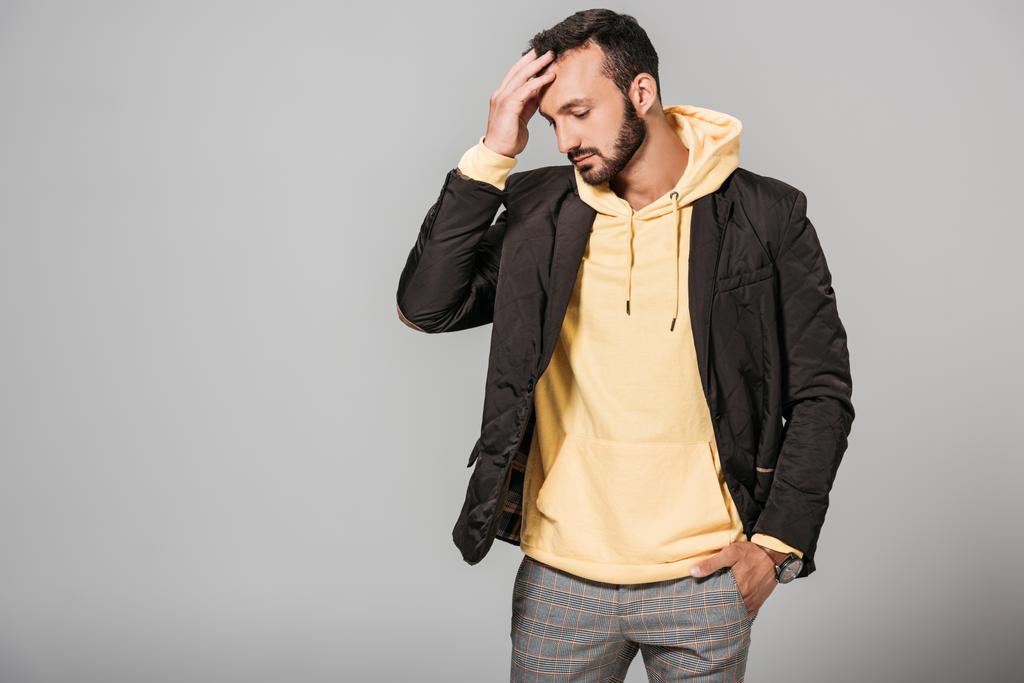 mladý muž ve stylové podzimní oblečení představuje izolované na šedém pozadí  - Fotografie, Obrázek
