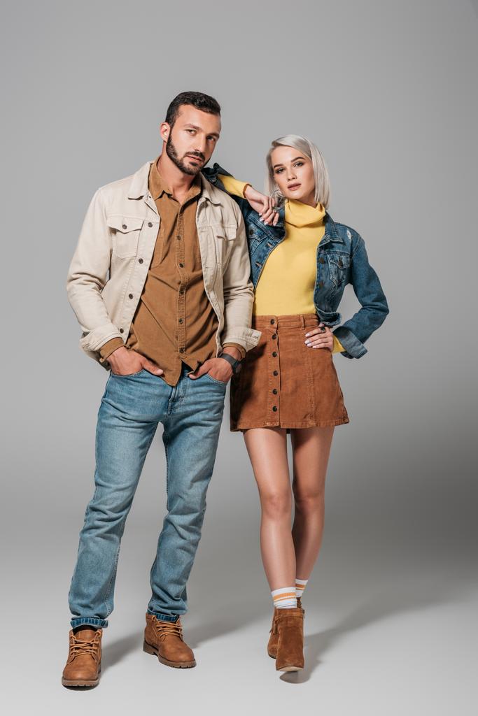 couple of models posing in street style autumn outfit, on grey - Photo, Image