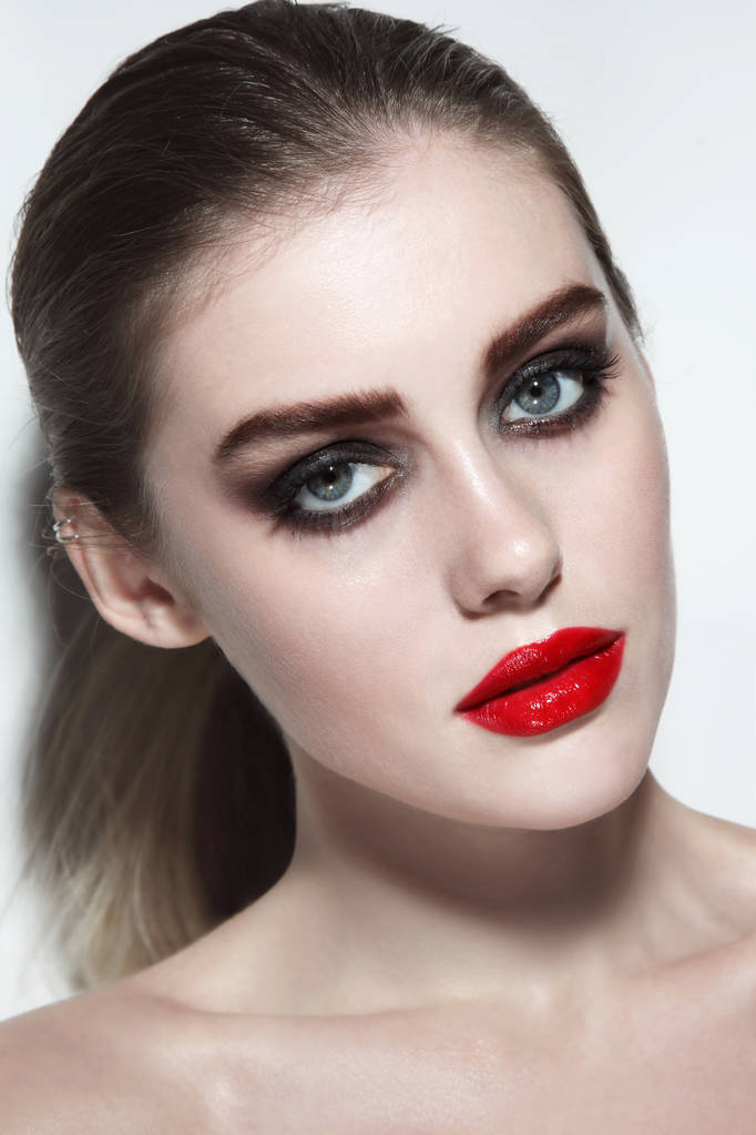 Joven hermosa mujer con lápiz labial rojo y maquillaje de ojos ahumados
 - Foto, Imagen