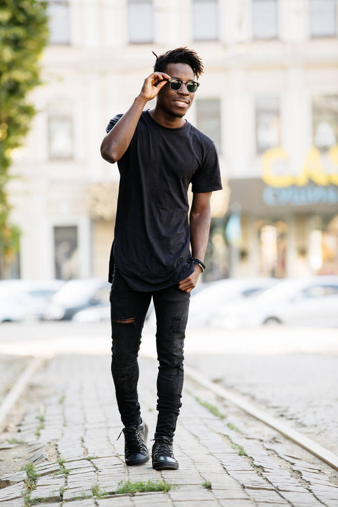 Genç Afrikalı model adam siyah t-shirt sokak kenti olarak ayakta - Fotoğraf, Görsel