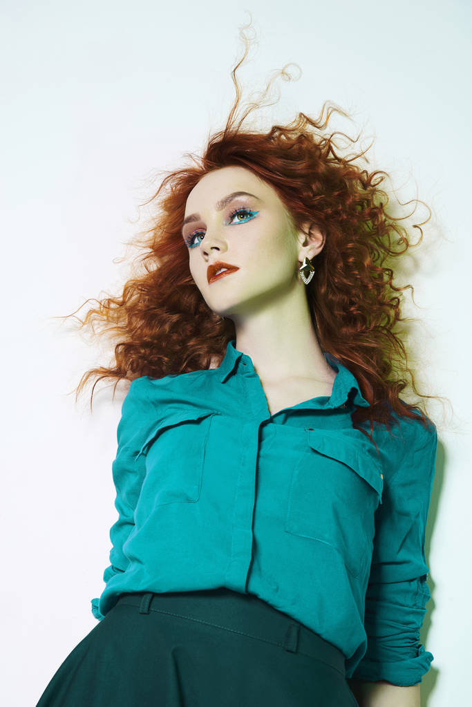 beleza cabelo vermelho jovem mulher posando em studio.beautiful menina gengibre com maquiagem de cor e penteado encaracolado
 - Foto, Imagem