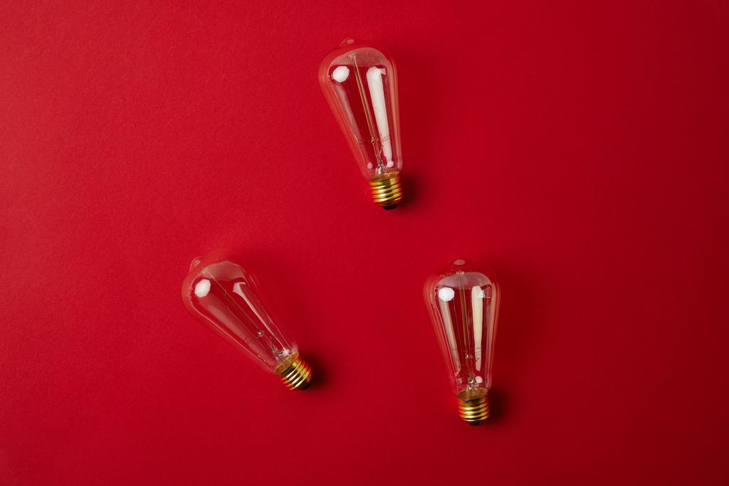 top view of vintage incandescent lamps on red tabletop - Photo, Image