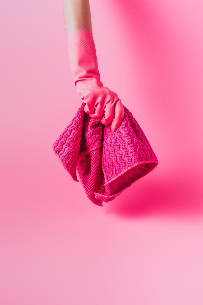 partial view of female cleaner in rubber glove holding rag, pink background - Photo, Image