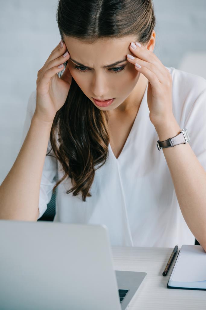 young businesswoman suffering from headache while working with laptop  - Photo, Image