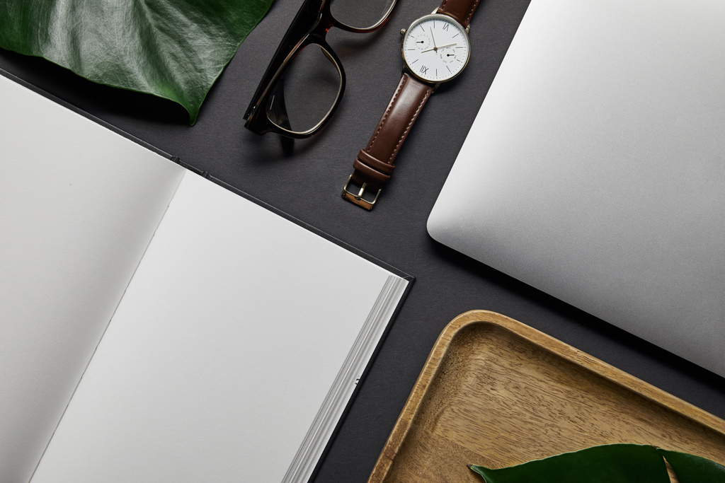 Flat lay template with open notebook and laptop on black background - Photo, Image