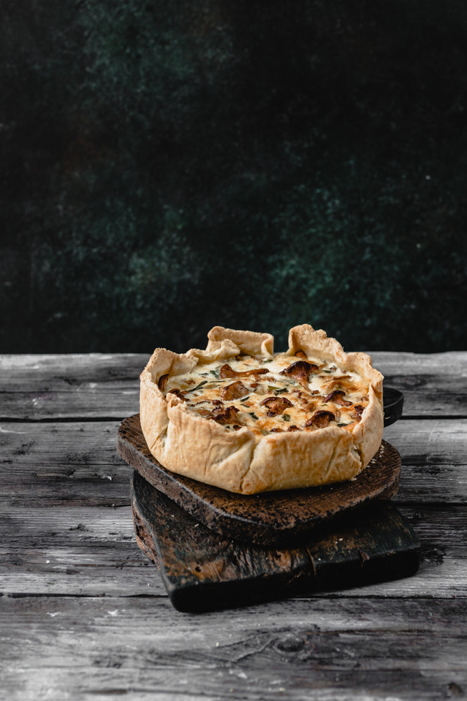 cooked appetizing pie with mushrooms on wooden table - Photo, Image