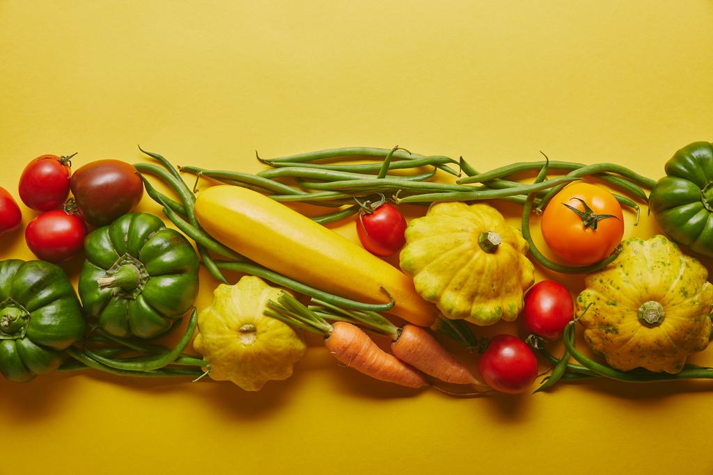 Bright wholesome vegetables on yellow background - Photo, Image